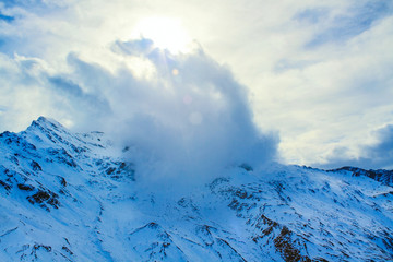 Fototapeta na wymiar A large cloud passes over a mountain, nationalpark Hohe Tauern; Austria