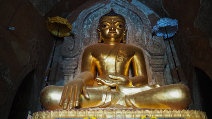 Bagan Myanmar - A Buddha statue at Ananda Temple in Bagan Myanmar. The Bagan Archaeological Zone is a main attraction for the country nascent tourism industry.
