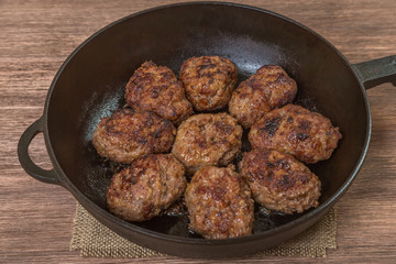 Homemade burgers in a frying pan. The view from the top. Space to insert text.