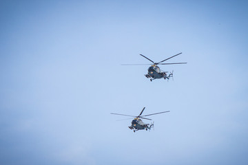 military helicopters flying in the blue sky