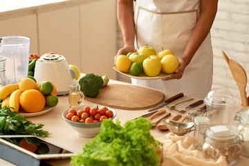 Obraz na płótnie Canvas Bringing fruits to the table