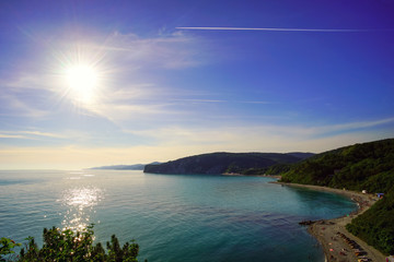 Bright sun over the beach and sea.
