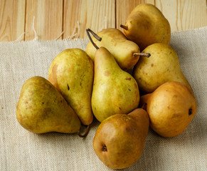 Fresh ripe organic Pears on wooden table on sackcloth.