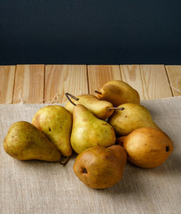 Fresh ripe organic Pears on wooden table on sackcloth.