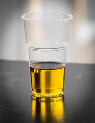 Fresh beer in a plastic glass on the table