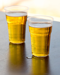 Fresh beer in a plastic glass on the table