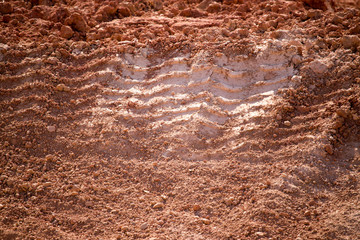 Traces from the car on the red clay soil
