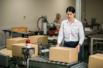 latina worker portrait in packaging plant.