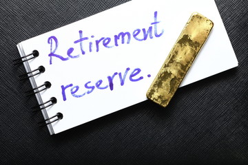 Notepad paper with hand writing text and gold bar.