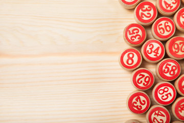 Bingo lotto on wooden background with copy space. Balls with bingo numbers. Flat lay.