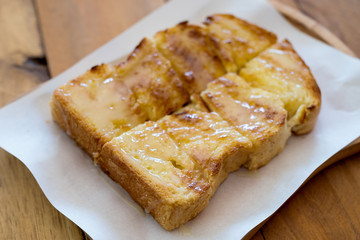 Closeup image of a piece of sliced bread toast with condensed milk
