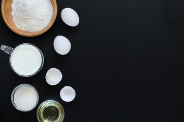 Ingredients for cooking on black background. Recipe of Russian pancakes