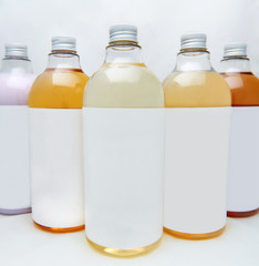 Set of different bottles for beauty, hygiene and health on a white background with reflection, they shampoo, conditioner and other hair products