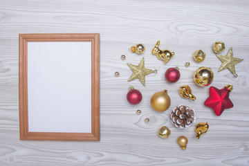 Naklejka na ściany i meble Christmas composition. Empty wooden frame and christmas gifts, toys on white wooden background. Flat lay, top view, copy space.
