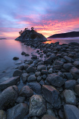 Fog and mist roll into Whytecliff Park at sunset producing some vivid colors in West Vancouver BC Canada.