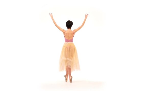ballerina is dancing in the studio on a white background - slow motion