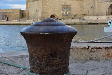 Italy, Puglia, Monopoli. Port with fishing boats. Ancient bollard