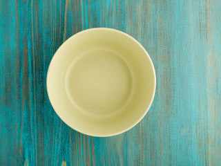 empty ceramic bowl for soup on the old wood turquoise table