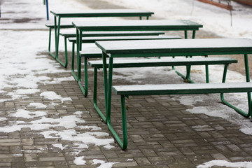 tables with snow on the street