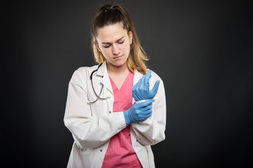 Young doctor portrait  holding wrist like hurting