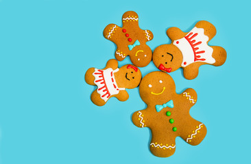 Gingerbread family on the blue background. Christmas and new year concept, copy space for text.
