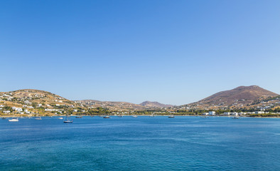 Fototapeta na wymiar Greece. Cyclades. Paros island. Picturesque white houses near Parikia town. Yachts in the sea