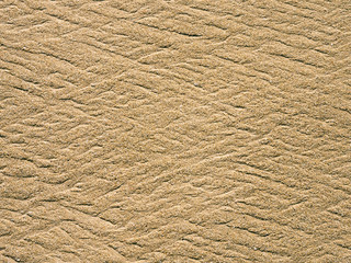 Background, sand on the beach after the departure of the wave