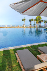 sun umbrella with tropical pool and seaside
