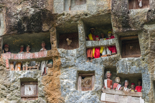 famous burial site with coffins placed in caves carved into the rock, guarded by the statues of the dead persons (called tau tau in local language). Tana Toraja, South Sulawesi