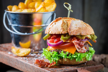 Closeup of fresh burger with onion, tomato and lettuce
