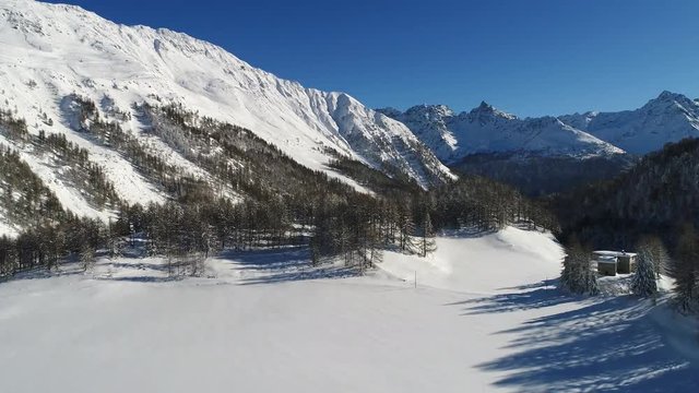 Flying over the forest in high mountain, winter season. Trees cover with snow