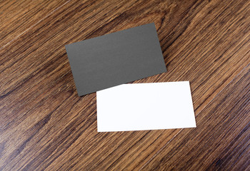 Mockup of white and black business cards at wooden background