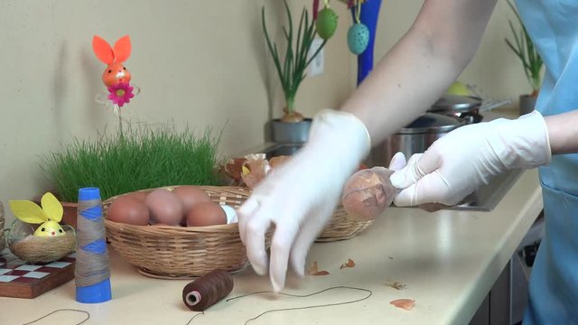 Painting Easter eggs using sock and onion shell.