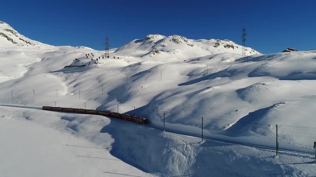 Red train in the Swiss Alps, Tirano - Engadine. Bernina Express, Unesco Heritage. December 2017