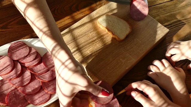 Slicing sausage on a cutting board. Beef sausage. Cut with a kitchen knife.Treat a sandwich