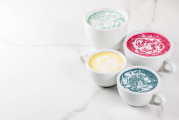 Organic vegan Latte coffee, decaffeinated - turmeric, beetroot, seaweed and matcha. On a white marble background, top view copy space
