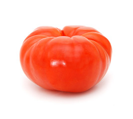 a wrinkled zapotec heirloom tomato on a white background
