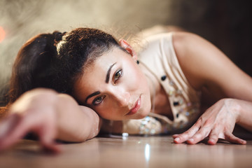 close-up portrait of young hot woman in sexy lingerie performs sensual pole dance. Go-go dancer on...