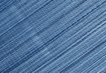 Blue toned straw mat surface.