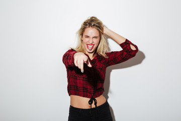 Fototapeta premium Emotional young blonde woman pointing to you.