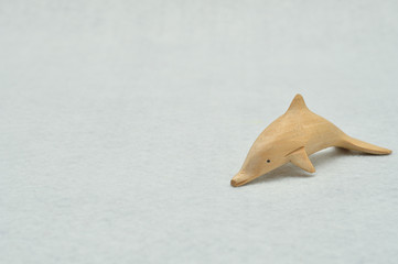 A dolphin wooden figurine isolated on a white background