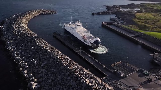 Aerial View of Ferry pulling into Marina in Denmark. Slow Rise with Tilt Down.