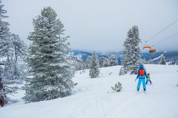 Fototapeta na wymiar Skiers in a winter ski resort.