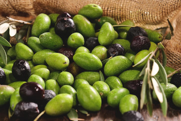 Genuine Italian organic oil cold pressed in slow motion falls on organic bread. concept of nature and healthy food, healthy and natural. fresh olives and Tuscan Italian oil