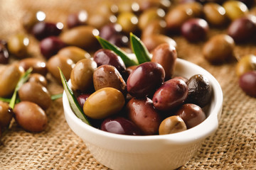 Genuine Italian organic oil cold pressed in slow motion falls on organic bread. concept of nature and healthy food, healthy and natural. fresh olives and Tuscan Italian oil