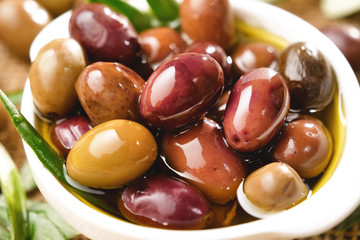 Genuine Italian organic oil cold pressed in slow motion falls on organic bread. concept of nature and healthy food, healthy and natural. fresh olives and Tuscan Italian oil