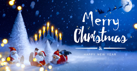 Fototapeta na wymiar Christmas tree and holidays Santa decoration ornaments; Santa Claus flying in his sleigh against moon sky