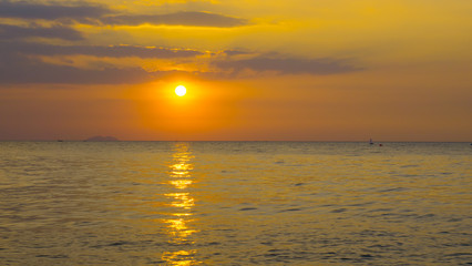 Sunset with golden sky and ocean.