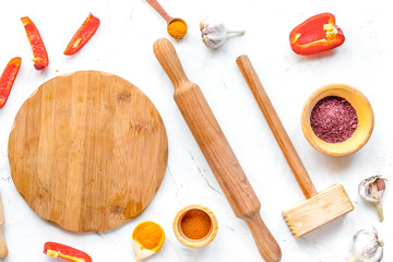 Cook workplace with kitchen tools, rolling-pin and spices white 