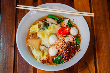 Noodle and dumpling with barbecued red pork.